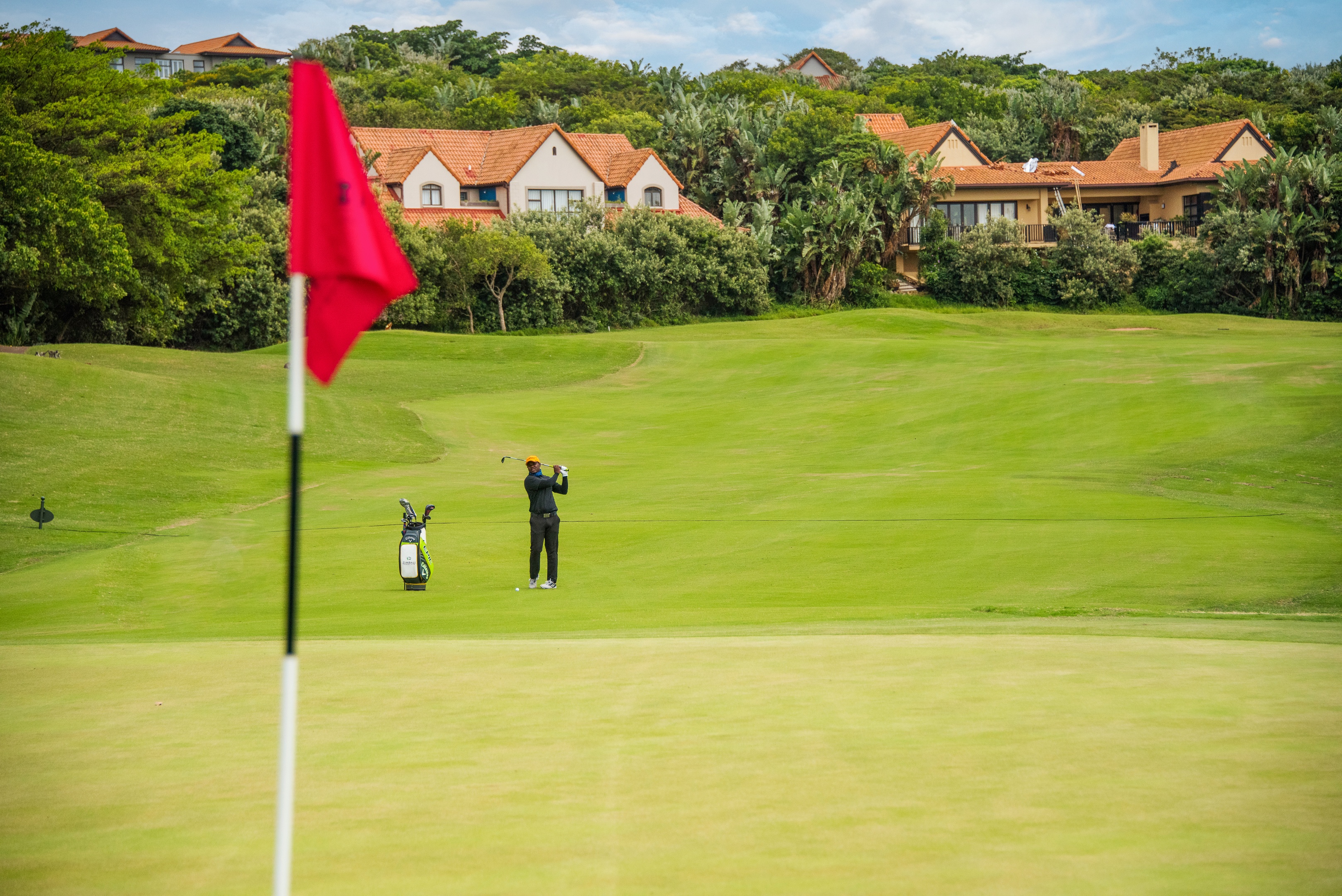 Fancourt clubhouse at sunset and the 18th hole with the Outeniqua mountains as a backdrop